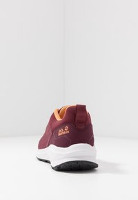 Maroon and orange Jack Wolfskin athletic shoe viewed from the back showing white sole and brand logo on the heel.