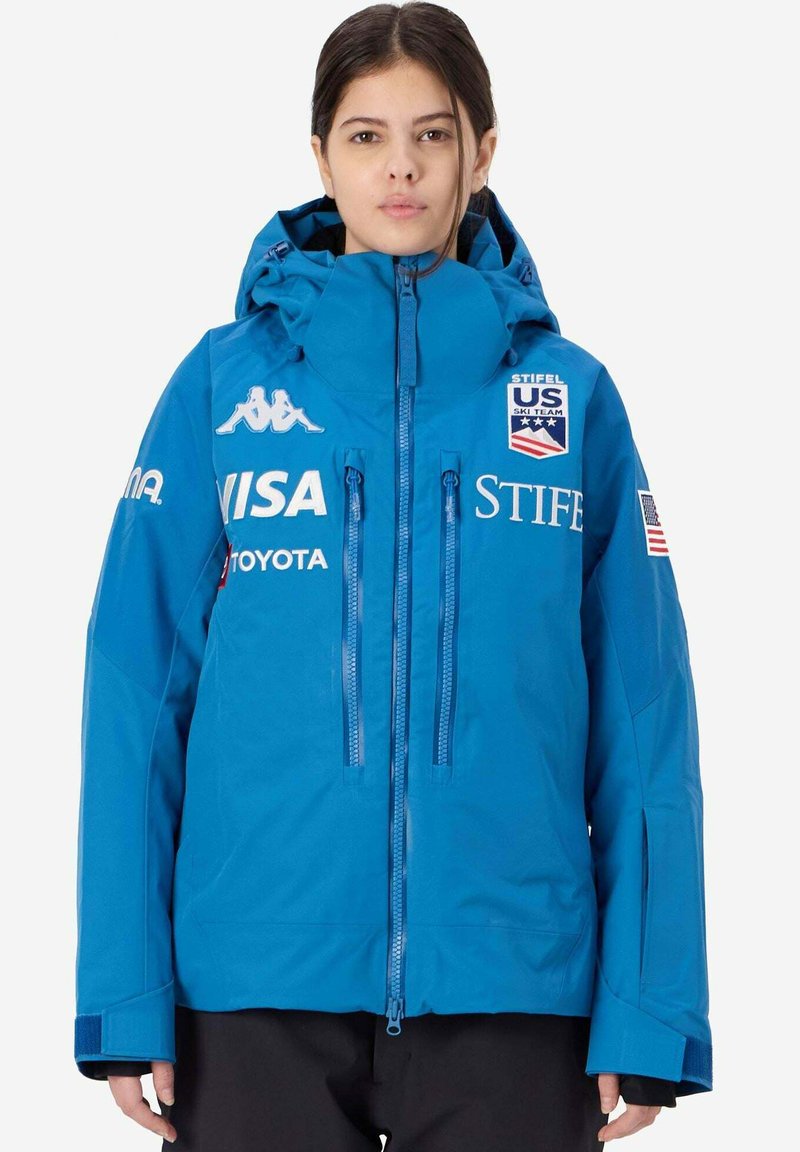 Giacca da sci blu con cappuccio, dotata di zip e loghi, realizzata in materiale impermeabile, con polsini elasticizzati e tasche laterali.