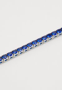 Bracciale in pietre preziose blu con pietre rotonde e sfaccettate montate su una base in metallo argentato, con maglie alternate aperte e chiuse.