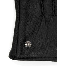 Schwarzes Lederportemonnaie mit strukturiertem Finish, ausgestattet mit einem silbernen Metallknopf mit eingeprägtem Logo. Kompakte rechteckige Form, genähte Kanten.