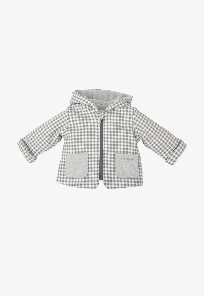 Chaqueta con capucha en gris y blanco de cuadros, con cremallera frontal, dos detalles de bolsillos grises y puños enrollados. Textura de tela suave.