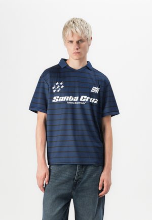 Navy blue striped polo shirt with a folded collar, featuring white text and small star graphics. Made from a lightweight fabric.