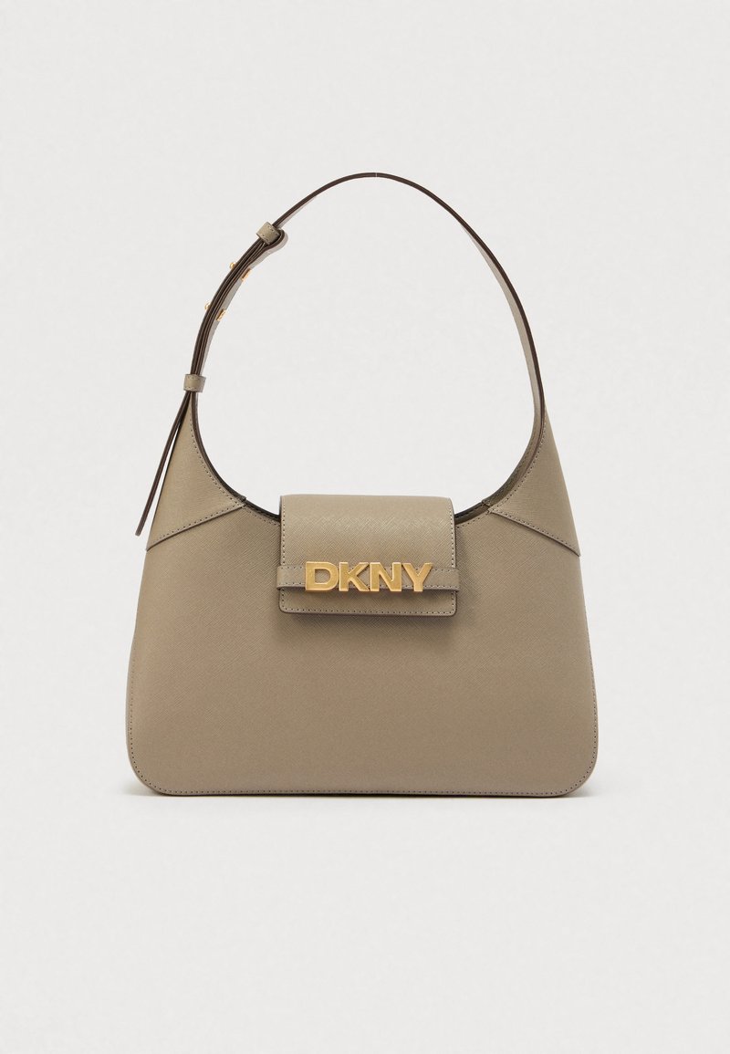 Beež värviga õlakott struktureeritud kujuga, millel on kuldne DKNY logo, sile pind ja üks reguleeritav rihm.