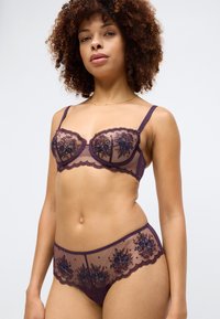 Purple lace bra and panty set featuring embroidered floral patterns, sheer mesh material, underwire support, and scalloped lace edges.
