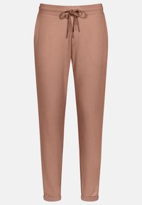 Pantalons de survêtement roses en tissu doux, avec une taille à cordon de serrage, des poches latérales et un design fuselé avec des ourlets resserrés.