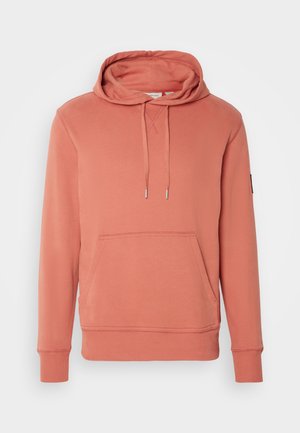 Sweatshirt rosa com capuz ajustável, bolso canguru, punhos e bainha canelados. Feito de um tecido macio com uma textura suave.