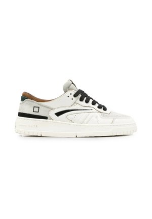 Lage witte en grijze sneaker met zwarte veters, zwarte accenten aan de zijkant en dikke witte zool tegen een witte achtergrond.