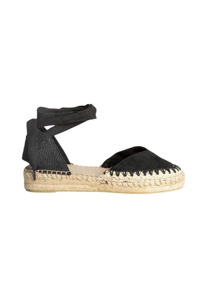 Espadrille negra con suela de yute trenzado, tejido que envuelve el talón y correas cruzadas para atar. Presenta un perfil plano y un diseño de punta afilada.