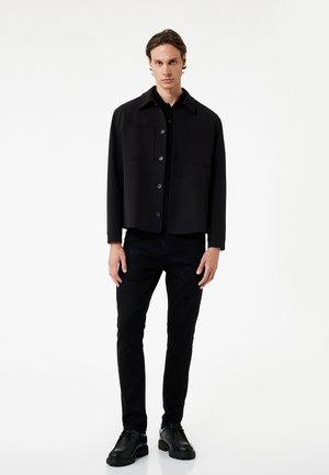 - Jeansy Slim Fit