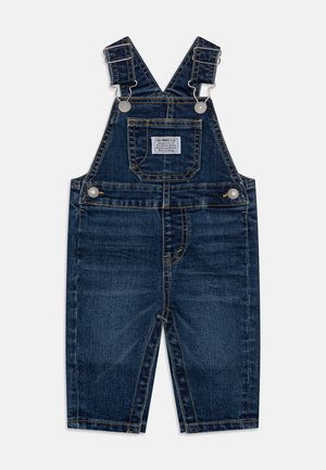 Mørkeblå denim buksedragt til småbørn med justerbare stropper, forlomme med label og sølvfarvede knaplukninger.