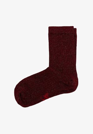 Calcetines burdeos de material texturizado con un acabado brillante. Presentan un puño acanalado y un pequeño logo rojo en el lateral.