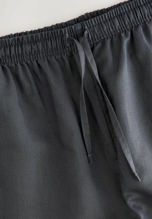 Dark gray shorts with an elastic waistband, featuring a drawstring and smooth texture. Simple design without patterns or hardware.