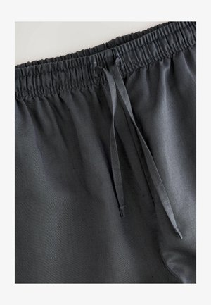 Shorts gris foncé avec une taille élastique, dotés d'un cordon de serrage et d'une texture lisse. Design simple sans motifs ni éléments métalliques.