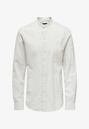 Camicetta a maniche lunghe in beige chiaro con sottili righe verticali. Collo alla mandarino e chiusura con bottoni davanti. Tessuto morbido con una texture liscia.