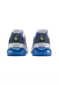 Nike Air Max sneakers with a white and grey mesh upper, blue textured heel, clear air cushion, and circular logo on the heel tab.