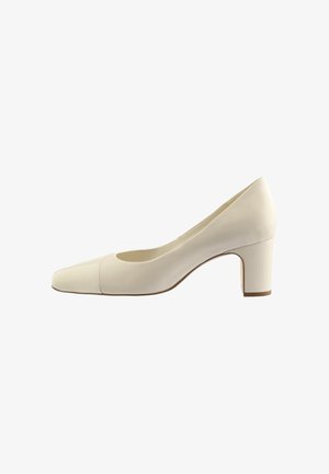 White leather pump with a pointed toe, low block heel, smooth texture, and a split color design at the toe. Simple, modern silhouette.