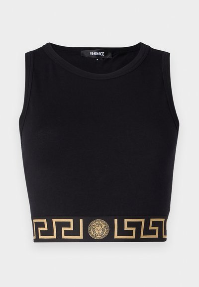 Black sleeveless crop top made of soft fabric, featuring a gold Greek key pattern and Medusa emblem on the hem. Classic design.