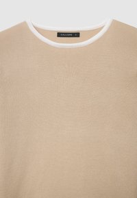 Beige sweater with a textured knit pattern, featuring a round white collar and a label reading "CALLIOPE" inside the neck. Size S.