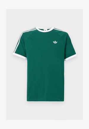 Grön bomull t-shirt med vita detaljer, kort ärm, rund halsringning och tre vita ränder på varje axel. Liten logga på bröstet.