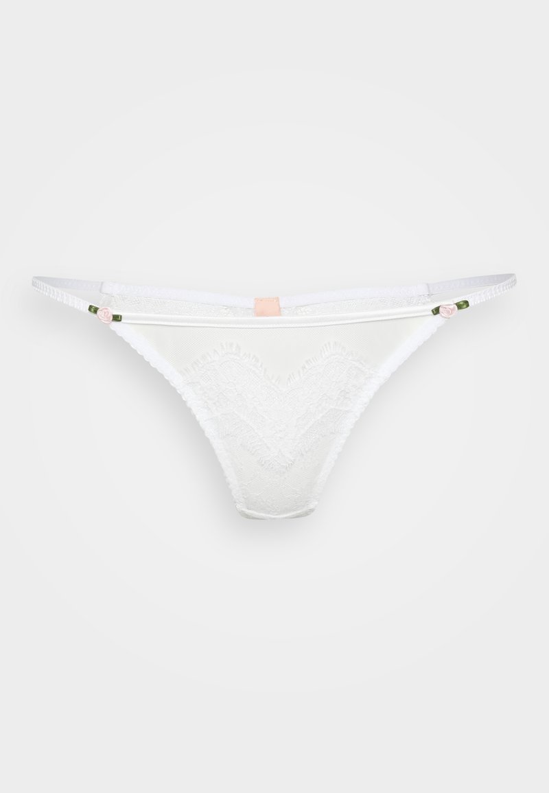 String en dentelle blanche avec un design festonné, des accents floraux délicats et des bretelles élastiques discrètes. Texture douce et matériau léger.