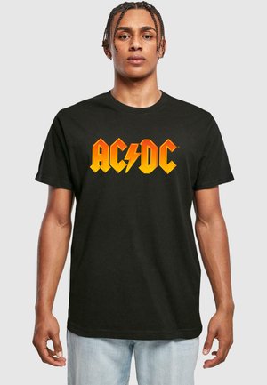 Black cotton t-shirt featuring a bold orange and yellow AC/DC logo across the chest, round neckline, and short sleeves.