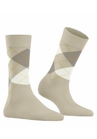 Beige strømper med diamantmønster i nuancer af grå og hvid, med gule accenter. Fremstillet af et glat, elastisk stof.