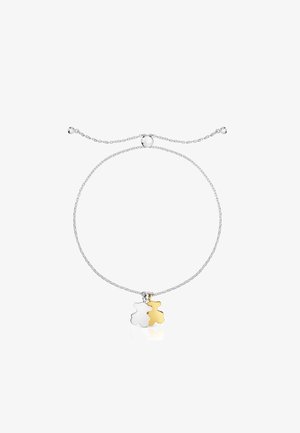 Silver chain bracelet with two bear charms: one silver and one gold. Features a sliding closure for adjustable length.