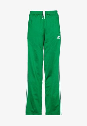 Pantaloni da tuta verdi Adidas con strisce bianche laterali, vita elastica, coulisse e logo sulla coscia sinistra.