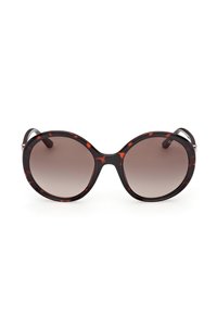 Lunettes de soleil rondes surdimensionnées avec montures en écaille de tortue et verres dégradés marron, présentées sur un fond blanc.