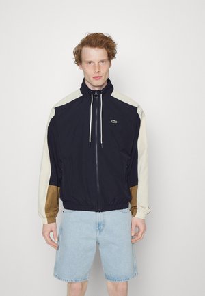 Lacoste Windbreaker - abysm/cookie lapland