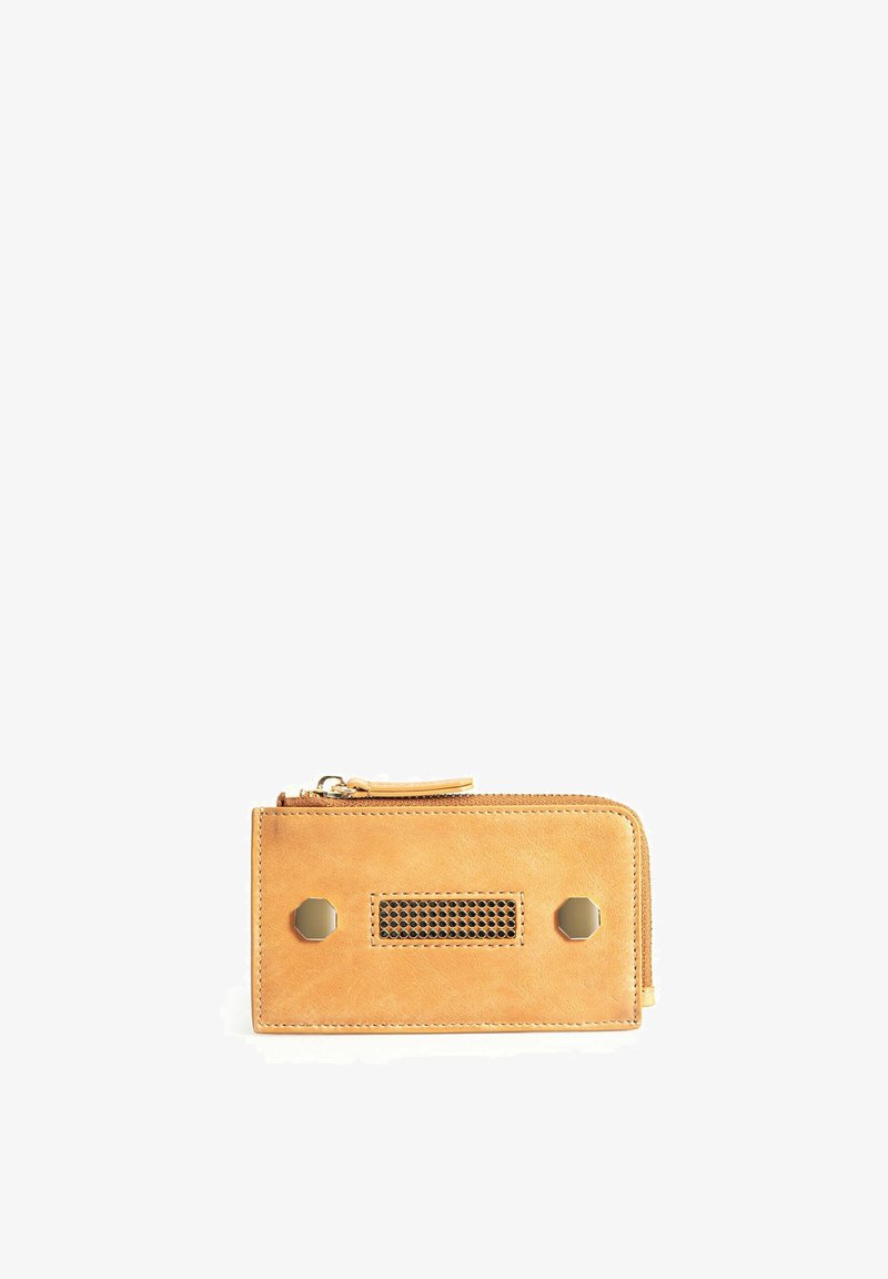 Tan leather wallet with a zip closure, featuring a mesh accent and two hexagonal metallic studs on the front, smooth texture.