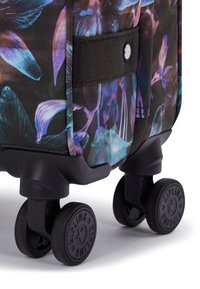 Rolling suitcase featuring a black fabric base with colorful floral patterns. It has four durable wheels and a textured handle for easy maneuvering.