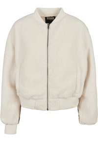 Cremefarget bomberjakke laget av teksturert fleece, med glidelås foran, ribbede mansjetter og kant. Myk, koselig og uformell design.