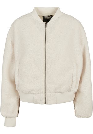 Cremefarget bomberjakke laget av teksturert fleece, med glidelås foran, ribbede mansjetter og kant. Myk, koselig og uformell design.