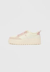 Light cream sneakers with pink suede accents, rubber sole, round toe, and lace-up closure. Featuring a logo detail on the side.