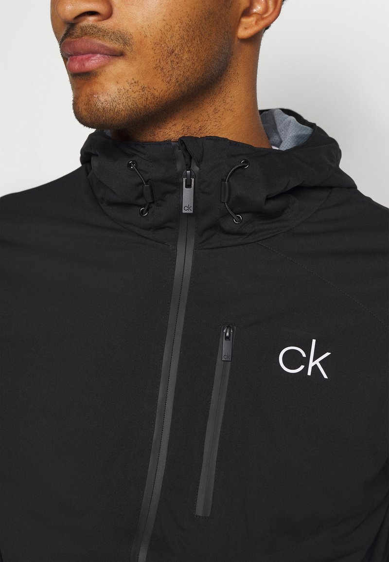 Calvin Klein Golf ULTRON HOODED JACKET - Waterproof jacket - black -  