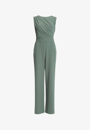 Vihreä hihaton haalari, jossa on laskeutuva yläosa ja leveälahkeinen malli. Valmistettu pehmeästä kankaasta, jossa rento istuvuus. Ei näkyviä koristuksia.