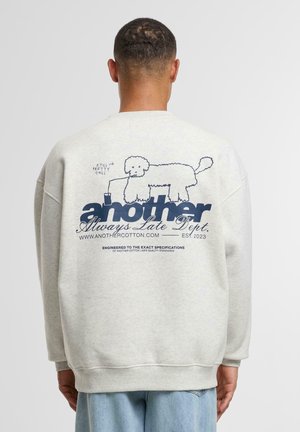 Light gray sweatshirt featuring a navy graphic of a dog with a drink, text reading "another Always Late Dept." and brand details.