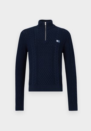 Marineblauer Strickpullover mit hohem Kragen und halbem Reißverschluss. Mit strukturierten Zopfmustern sowie gerippten Bündchen und Saum. Kleines Logo-Patch auf der Brust.