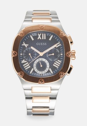Silver and rose gold stainless steel watch with a textured dark face, Roman numeral XII, two subdials, and flat-link bracelet.