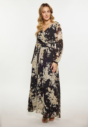 Florale maxi-jurk in zwart en crèmekleur, met lange mouwen, een wikkelontwerp en een ceintuur op de taille, gemaakt van een vloeiende, lichte stof.