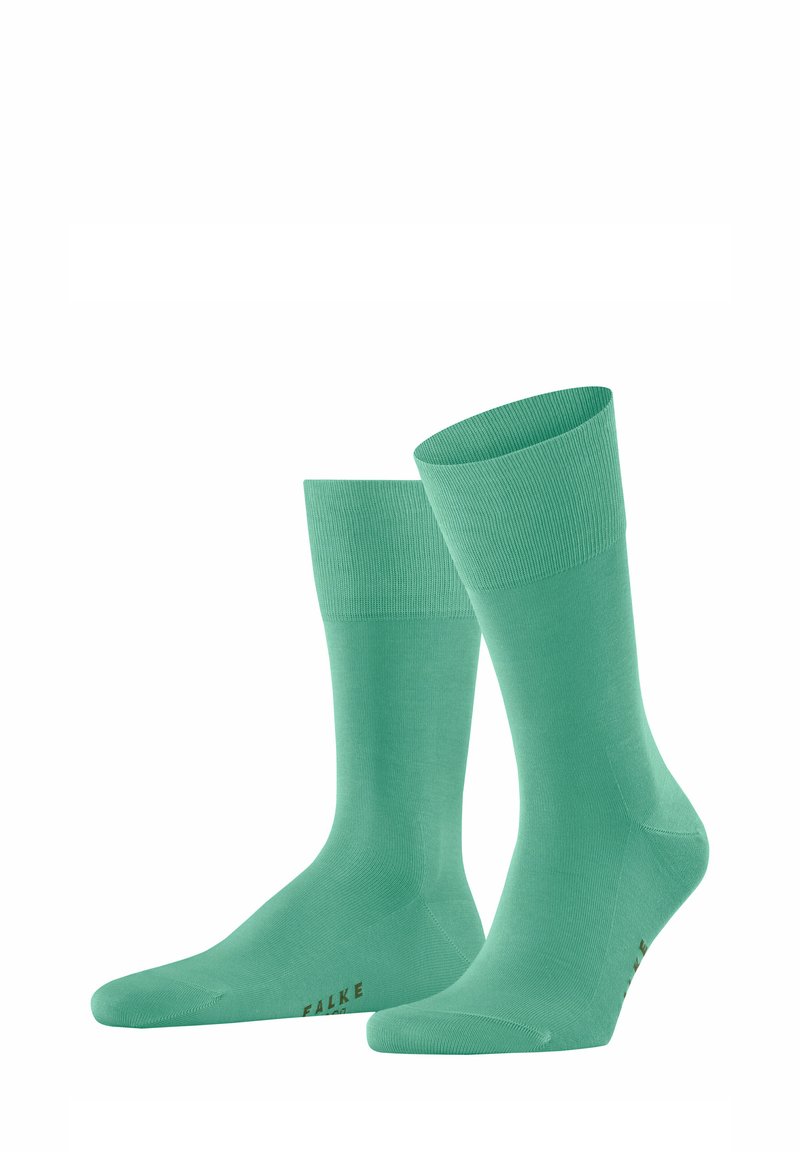 Grüne Baumwollsocken mit ribbeltem Bündchen, glatter Textur und braunem FALKE-Logo. Sie verfügen über einen Schafthöhe bis zur Mitte der Wade.