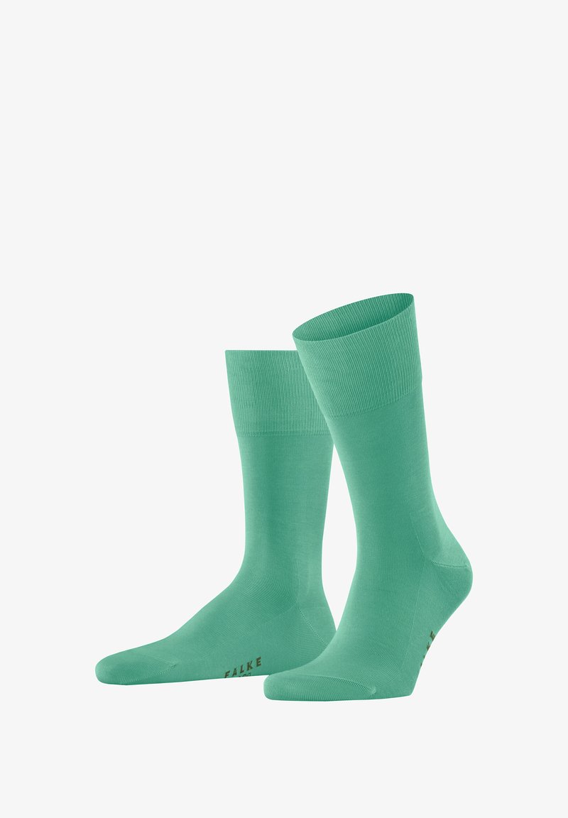 Grüne Baumwollsocken mit ribbeltem Bündchen, glatter Textur und braunem FALKE-Logo. Sie verfügen über einen Schafthöhe bis zur Mitte der Wade.