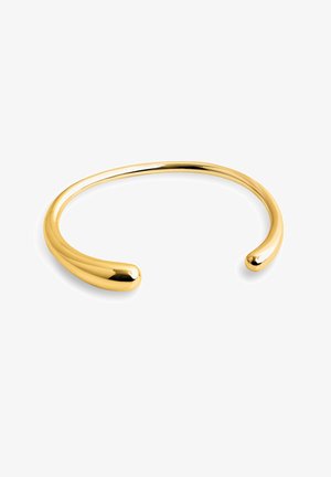 Zlatý náramok s hladkým, lesklým povrchom, otvoreným dizajnom s okrúhlymi koncami a elegantnou, minimalistickou estetikou.