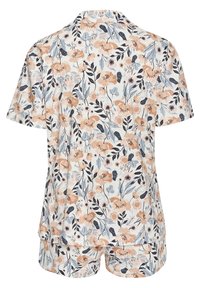 Floral short-sleeve pajama set featuring peach and navy flowers on a light background; soft fabric, button-up top, and short bottoms.