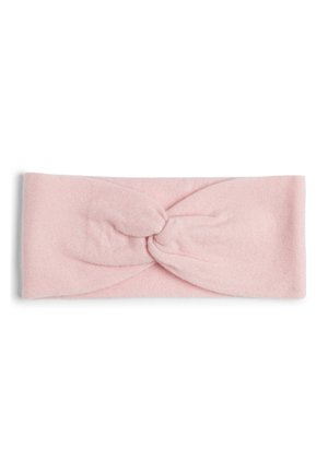 Pink fabric headband featuring a twisted knot design at the front, soft texture, and a seamless, wide band style.