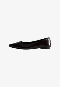 Bailarinas de charol negro con punta afilada y tacón plano. Superficie suave con un acabado brillante, con un diseño minimalista.