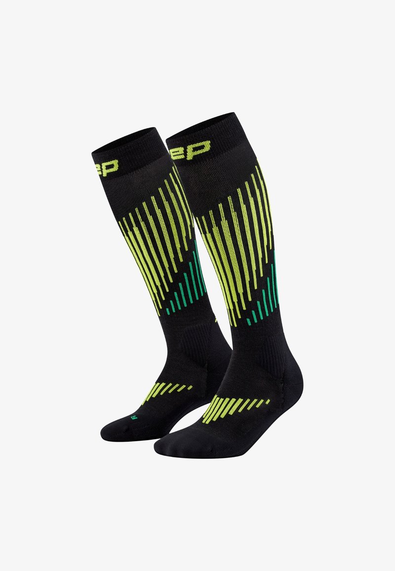 Kniestrümpfe in Schwarz mit vertikalen Streifen und Mustern in Grün und Gelb. Hergestellt aus einem Verbundstoff mit strukturierter Oberfläche.