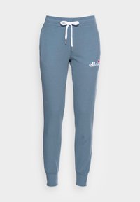 Blue cotton sweatpants with white drawstring and ribbed cuffs. Features a logo on the left thigh. Smooth texture with a tapered fit.