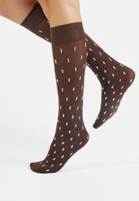 Brown knee-high socks featuring a light-colored polka dot pattern, with a smooth texture and ribbed cuff at the top.